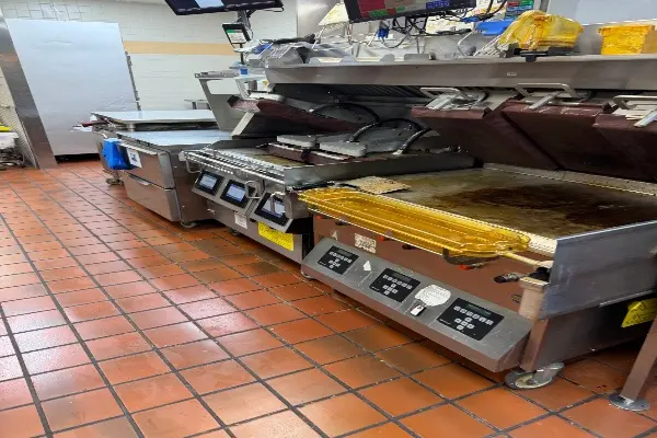 Commercial kitchen with industrial fryers and equipment.